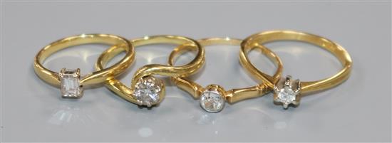 Four assorted 18ct gold and solitaire diamond rings.